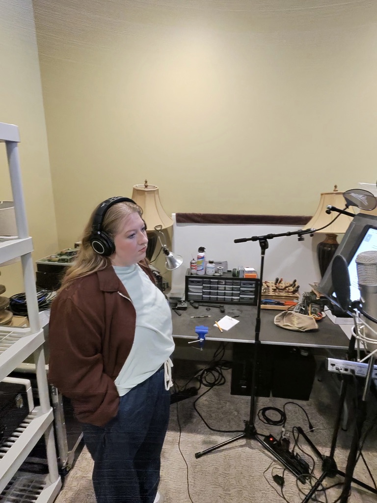 Caitlyn recording vocals in the studio